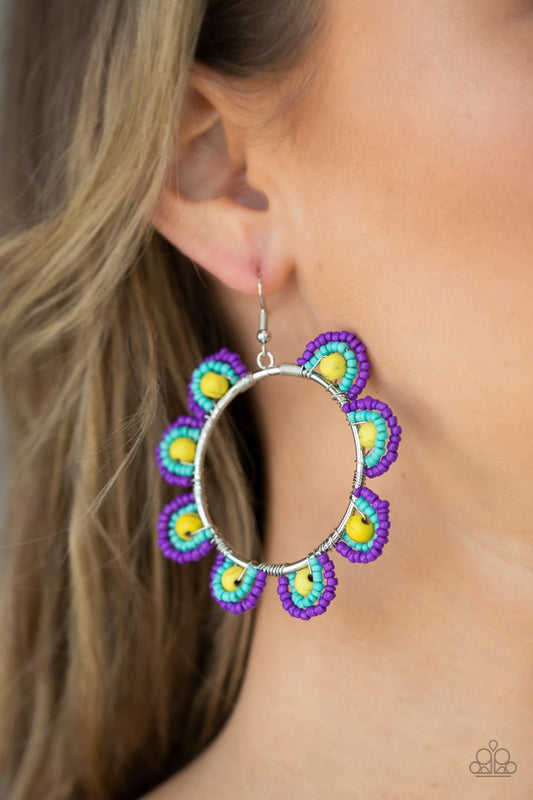 Paparazzi Groovy Gardens - Yellow Seedbead Earrings infused with sunny yellow stone bead centers, rows of purple and turquoise seed beads are threaded along dainty wires along the outside of a shiny silver hoop for a vivacious floral look. Earring attaches to a standard fishhook fitting.  Sold as one pair of earrings.
