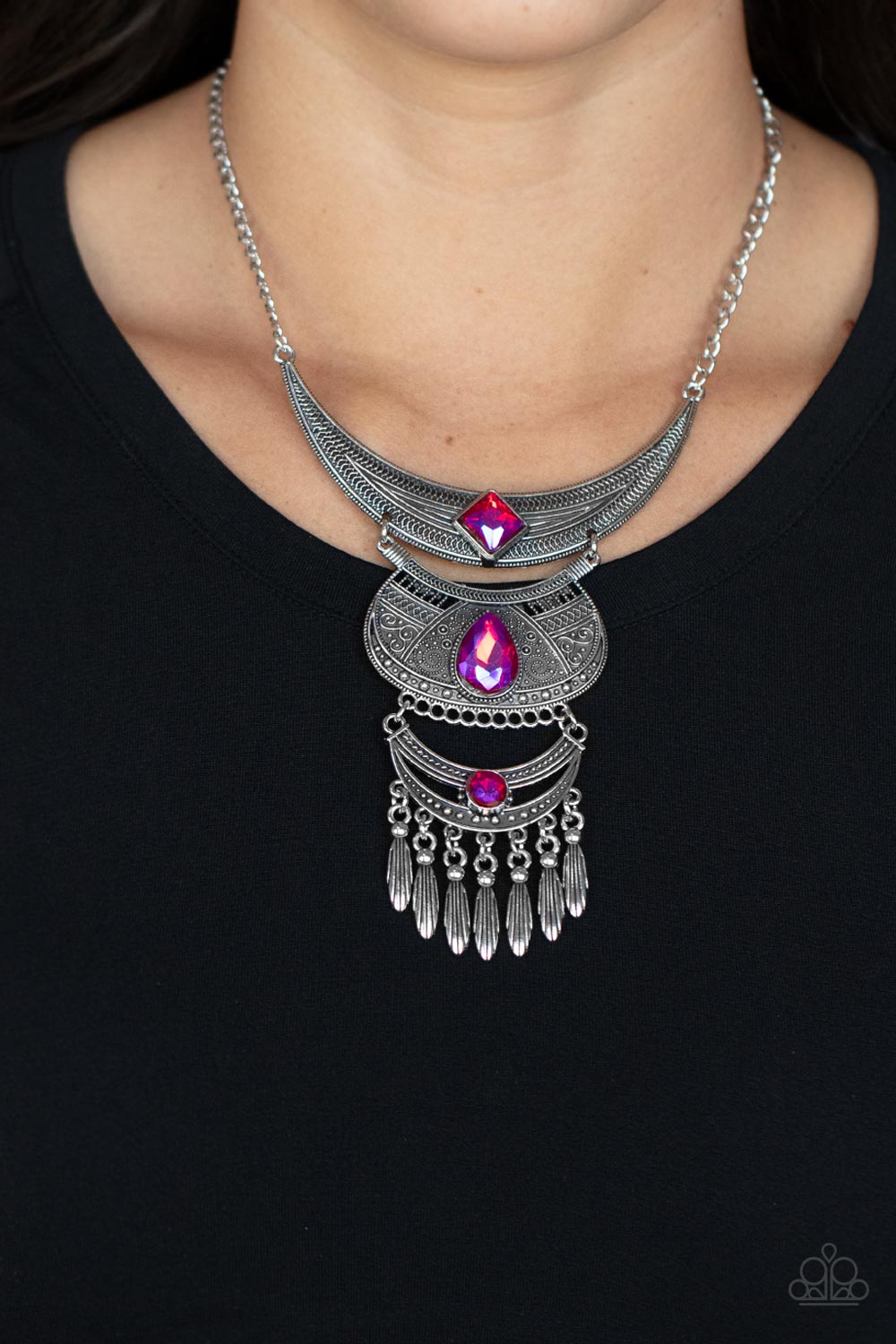 Lunar Enchantment - Pink Rhinestone Necklaces embossed in studded, geometric, and paisley filigree-like patterns, three mismatched silver half moon plates dramatically link below the collar. Featuring an entrancing pink UV shimmer, an oversized collection of square, teardrop, and round rhinestones embellish the decorative silver frames, while a silver beaded fringe swings from the lowermost plate for a noisemaking finish. Features an adjustable clasp closure. Sold as one individual necklace.