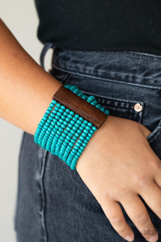 Paparazzi Waikiki Wonderland - Blue Wood Bracelets held together with brown wooden rectangular frames, rows of refreshing blue wooden beads are threaded along stretchy bands around the wrist for a whimsically layered look.  Sold as one individual bracelet.