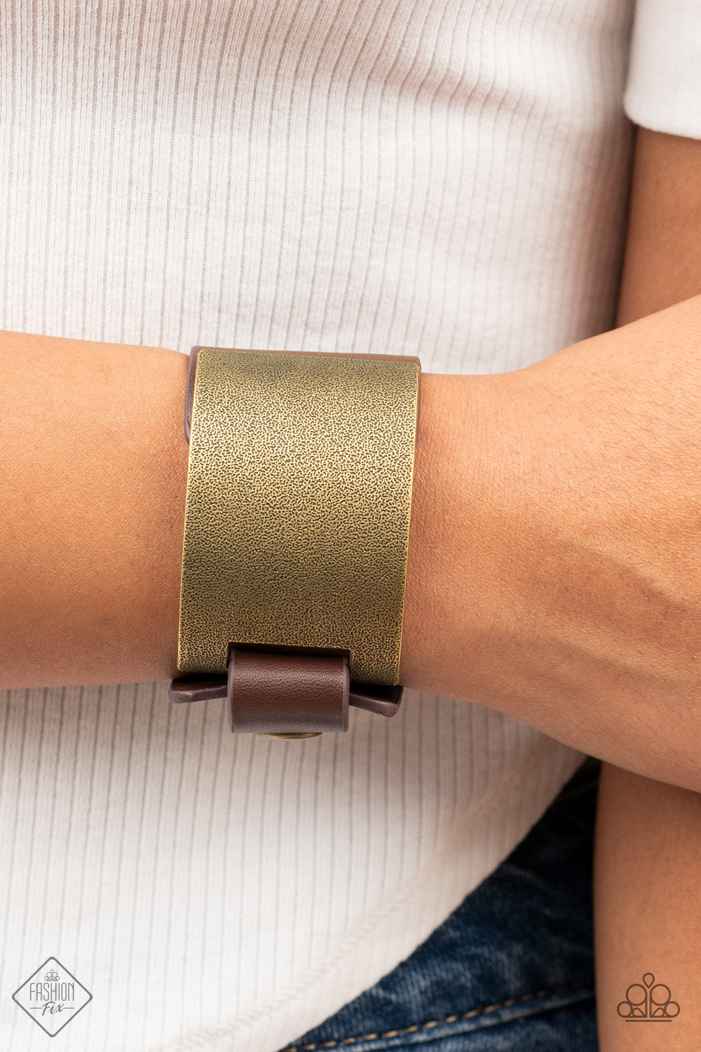 Studded Synchronism - Brass Wrap Bracelets curved brass panel, coated in antiqued texture, attaches to a wide brown leather band with brass snaps resulting in an edgy industrial element around the wrist. Features an adjustable snap closure. Sold as one individual bracelet. Paparazzi Jewelry is lead and nickel free so it's perfect for sensitive skin too!