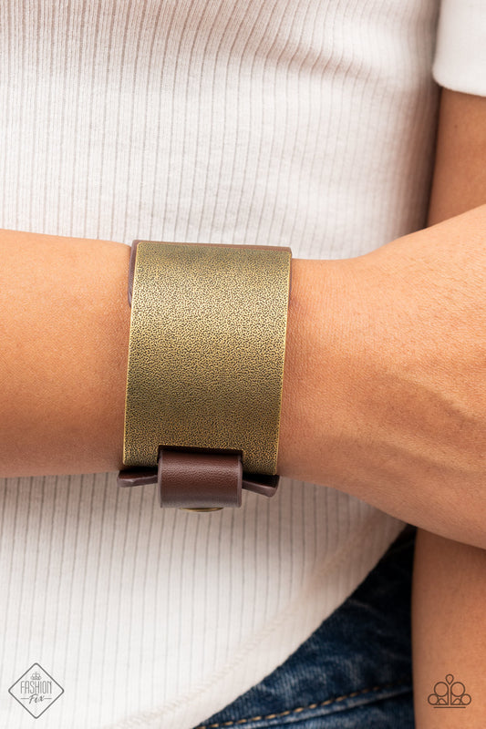 Studded Synchronism - Brass Wrap Bracelets curved brass panel, coated in antiqued texture, attaches to a wide brown leather band with brass snaps resulting in an edgy industrial element around the wrist. Features an adjustable snap closure.  Sold as one individual bracelet.  Paparazzi Jewelry is lead and nickel free so it's perfect for sensitive skin too!