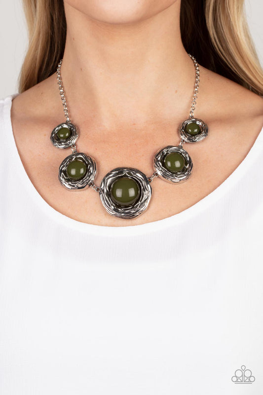 The Next NEST Thing - Green Stone Necklaces gradually increasing in size, a bubbly collection of oversized Olive Branch beads adorn the centers of folds of silver buds below the collar for a seasonal fashion. Features an adjustable clasp closure. Sold as one individual necklace. Includes one pair of matching earrings.