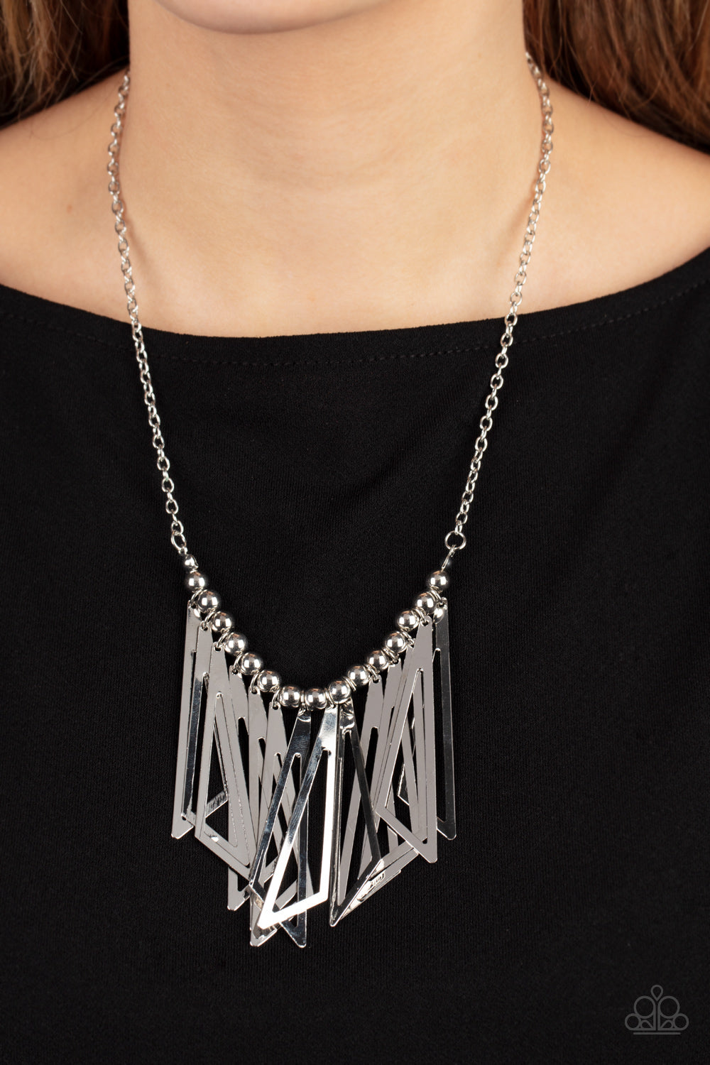 Industrial Jungle - Silver Triangular Frame Necklaces - Paparazzi Accessories flared silver triangular frames swing from a silver beaded chain below the collar, creating an intense industrial-inspired fringe at the bottom of a classic silver chain. Features an adjustable clasp closure.  Sold as one individual necklace. Includes one pair of matching earrings.