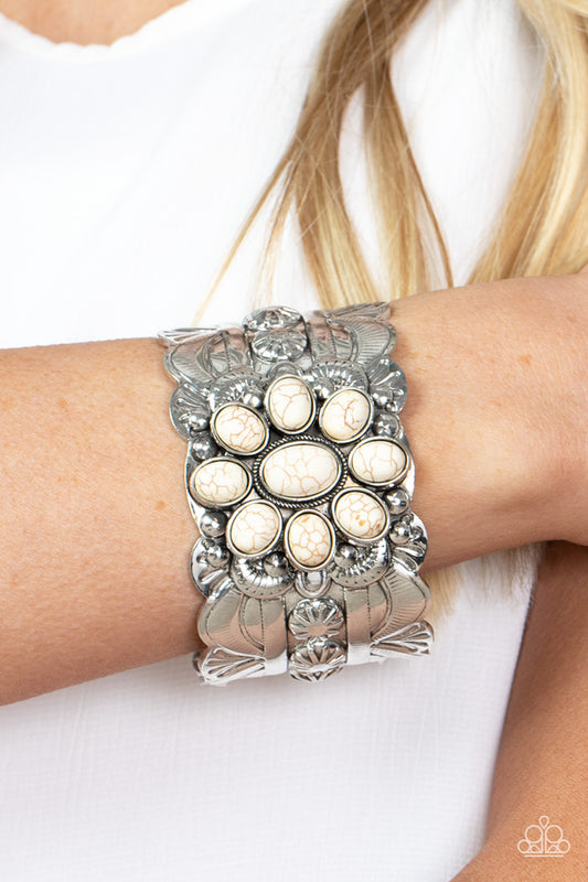 Southern Eden - White Stone Cuff Bracelets earthy white stones adorn the center of a substantial silver cuff that is studded and embossed in scalloped and sunburst accents, creating a floral centerpiece around the wrist.  Sold as one individual bracelet.