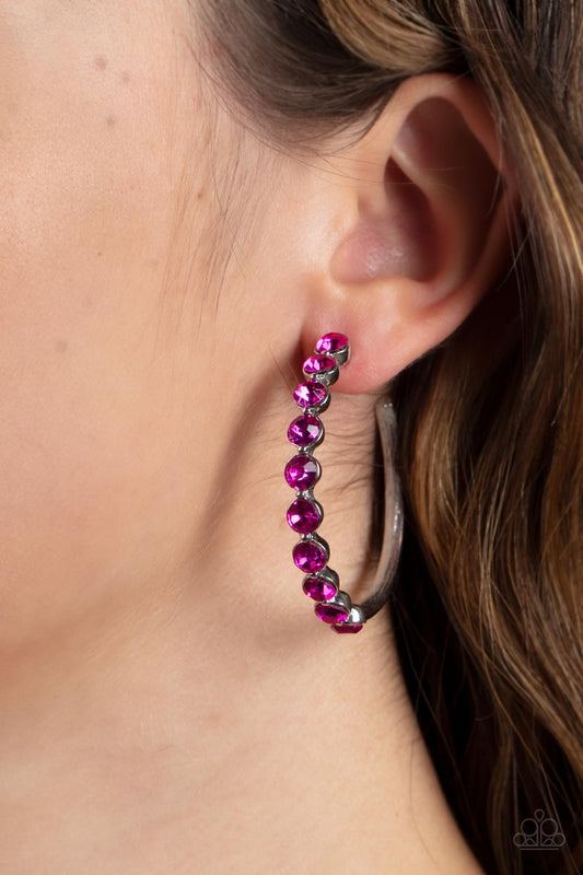 Photo Finish - Pink Rhinestone Hoop Earrings the front of a bold silver hoop is encrusted in flamboyant Fuchsia Fedora rhinestones, creating a glamorous pop of sparkle. Earring attaches to a standard post fitting. Hoop measures approximately 1 3/4" in diameter.  Sold as one pair of hoop earrings.