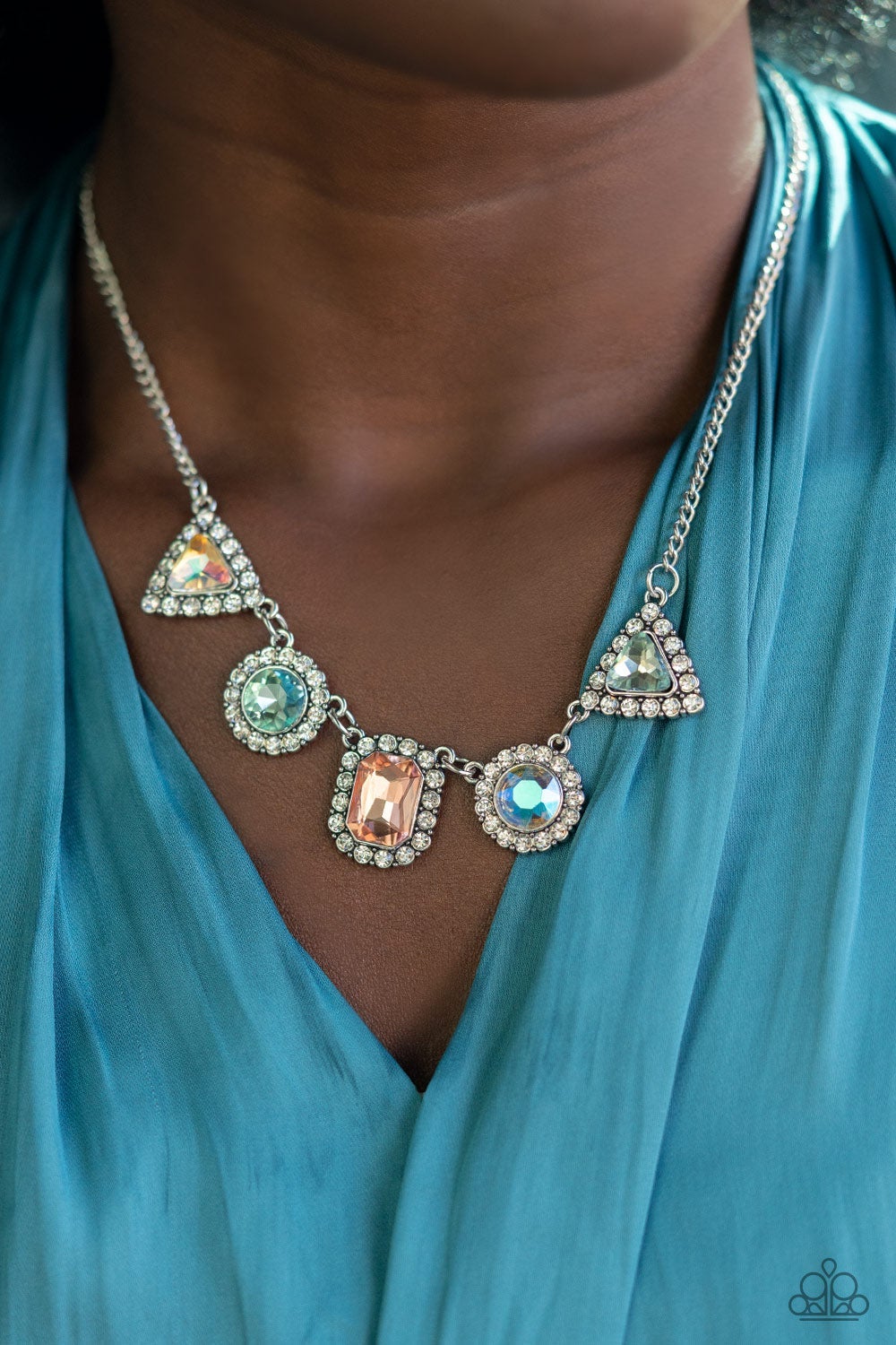 Posh Party Avenue - Multi Rhinestone LOP Necklace featuring triangular, round, and emerald style cuts, an iridescent collection of multicolored rhinestones are bordered in glassy white rhinestones as they delicately link below the collar for a sparkly statement. Features an adjustable clasp closure. Sold as one individual necklace. Includes one pair of matching earrings.