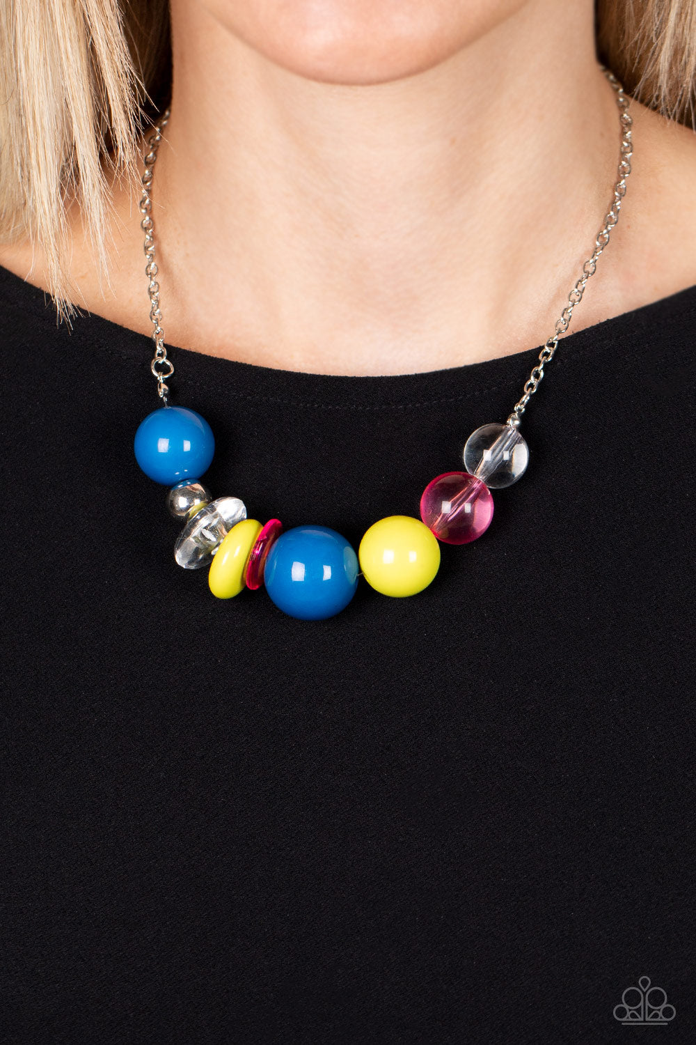 Bauble Bonanza - Multi Bead Necklaces infused with a single silver bead, an oversized collection of glassy and polished acrylic beads and rings are threaded along an invisible wire below the collar for a flamboyant fashion. Features an adjustable clasp closure. Sold as one individual necklace. Includes one pair of matching earrings.