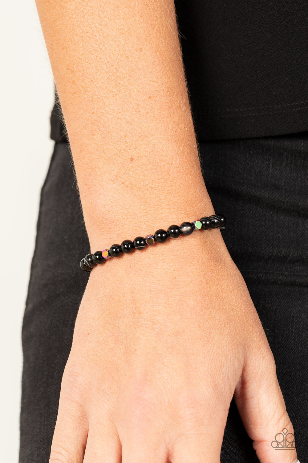 Interstellar Solitude - Black Stone Oil Spill Bracelets - Paparazzi Accessories a dainty collection of natural-finished black stone beads and faceted metallic oil spill cube beads are threaded along a stretchy band around the wrist for an earthy flair. Sold as one individual bracelet.