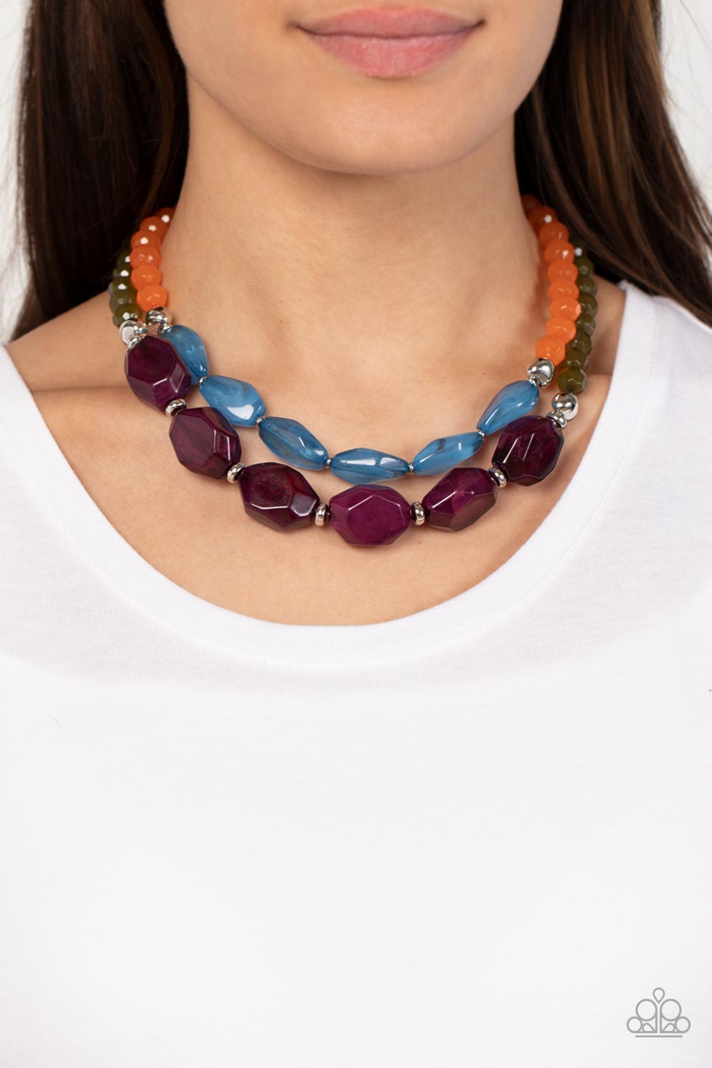 Paparazzi Accessories - Tropical Trove - Purple Necklaces faceted strands of opaque orange and Olive Branch crystal-like beads give way to a colorful assortment of oversized blue and plum crystal-like accents. Shiny silver beads adorn the hearty layers, adding a dash of metallic glitz to the tropical inspired display. Features an adjustable clasp closure.  Sold as one individual necklace. Includes one pair of matching earrings.