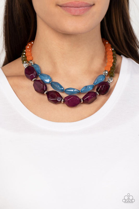 Paparazzi Accessories - Tropical Trove - Purple Necklaces faceted strands of opaque orange and Olive Branch crystal-like beads give way to a colorful assortment of oversized blue and plum crystal-like accents. Shiny silver beads adorn the hearty layers, adding a dash of metallic glitz to the tropical inspired display. Features an adjustable clasp closure.  Sold as one individual necklace. Includes one pair of matching earrings.