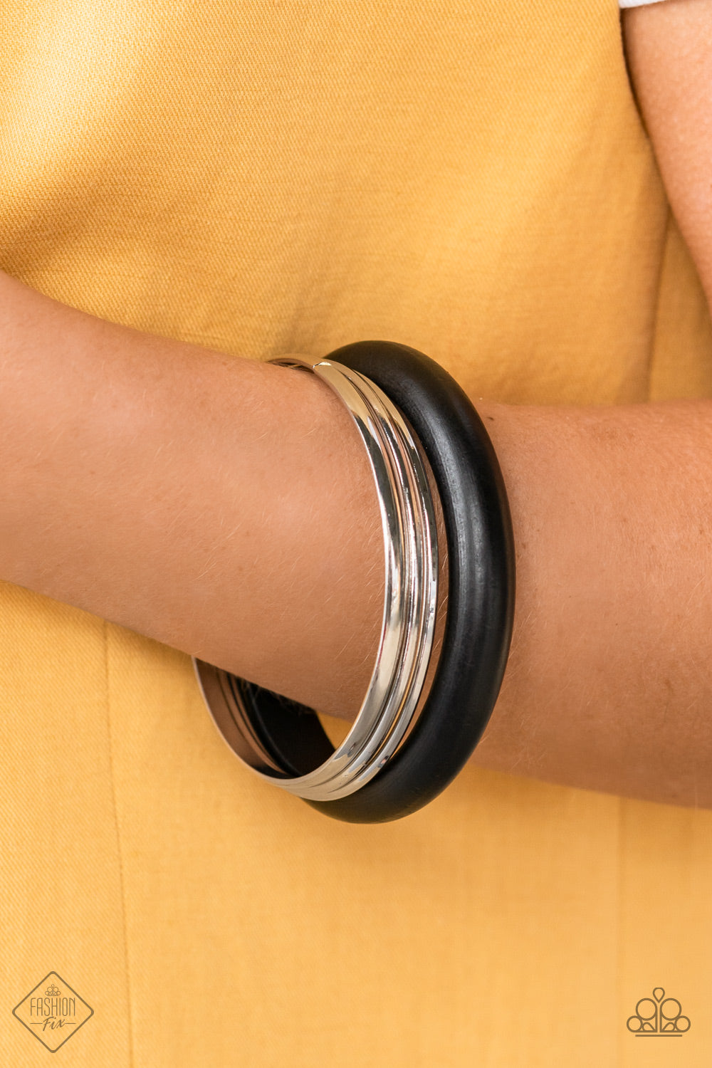 Adventurous Attitude - Black Bangle Bracelets a set of three basic silver bangles stack together with a chunky black wooden bangle for a layered look. Sold as one individual bracelet.