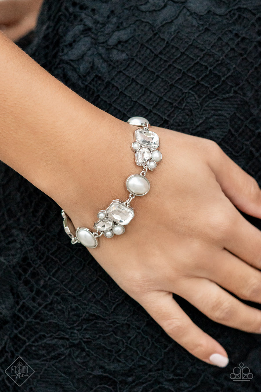 Best in SHOWSTOPPING - White Pearl Bracelets showstopping teardrop and emerald cut rhinestones, accented with bubbly pearl beads, coalesce into stunning asymmetrical frames. A trio of elegant white oval pearl beads delicately alternate with the asymmetrical renditions for a glamorous finish around the wrist. Features an adjustable clasp closure. Sold as one individual bracelet.