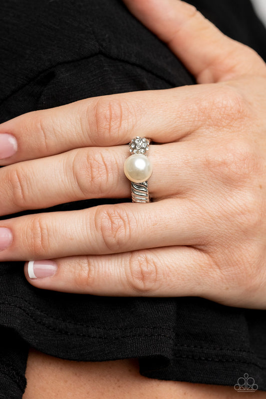 Paparazzi Accessories - A-List Applique - White Pearl Rings an oversized white pearl and white rhinestone encrusted silver bead embellish the front of a serrated silver band, resulting in a bubbly centerpiece atop the finger. Features a dainty stretchy band for a flexible fit.  Sold as one individual ring.