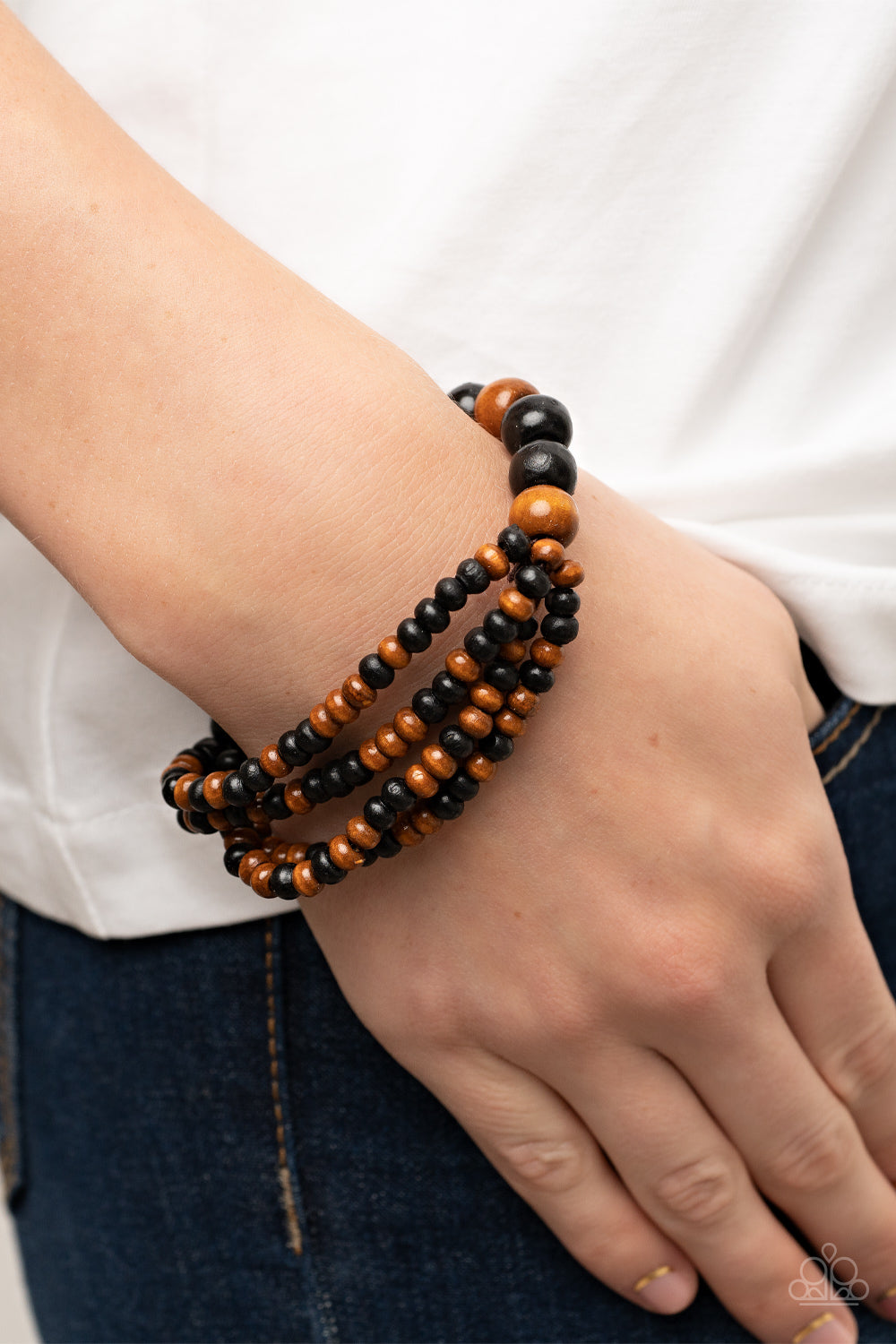 Oceania Oasis - Black Wood Bracelets stretchy strands of dainty brown and black wooden beads attach to a single strand of oversized brown and black wooden beads, resulting in colorful layers around the wrist. Sold as one individual bracelet.