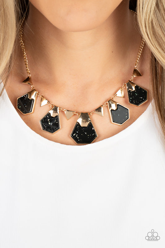 Paparazzi Accessories - Extra Exclusive - Black Necklaces flecked in iridescent shell-like accents, geometric black acrylic frames are pinched in placed by folds of gold atop the front of flat gold frames. The glimmering frames alternate with dainty gold triangular frames below the collar, resulting in a stellar fringe. Features an adjustable clasp closure.  Sold as one individual necklace. Includes one pair of matching earrings.