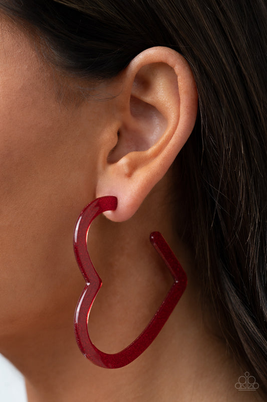 Heart-Throbbing Twinkle - Red Heart Hoop Earrings dusted in sparkles, a red acrylic frame delicately curls into a flat heart frame for a flirtatious finish. Earring attaches to a standard post fitting. Hoop measures approximately 2 1/2" in diameter.  Sold as one pair of hoop earrings.