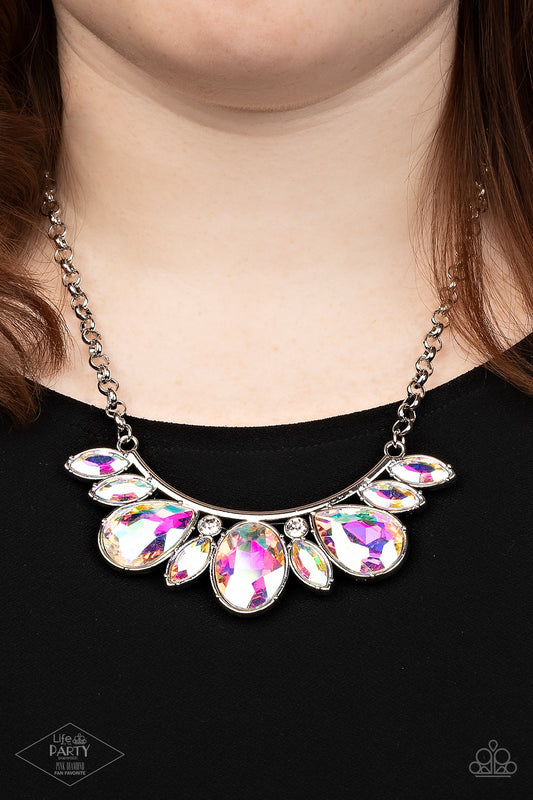 Paparazzi Never Slay Never - Iridescent Multi Necklaces infused with a pair of glassy white rhinestones, an oversized collection of marquise and teardrop iridescent rhinestones drips from the bottom of a bowing silver bar, coalescing into a sassy statement piece below the collar. Features an adjustable clasp closure.  Sold as one individual necklace. Includes one pair of matching earrings.  Life of the Party