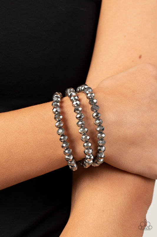 Paparazzi Accessories Supernova Sultry - Silver Magnetic Bracelets rows of hematite crystal-like beads are threaded along invisible wires around the wrist, layering into a smoldering sparkle. Features a magnetic closure.  Sold as one individual bracelet.