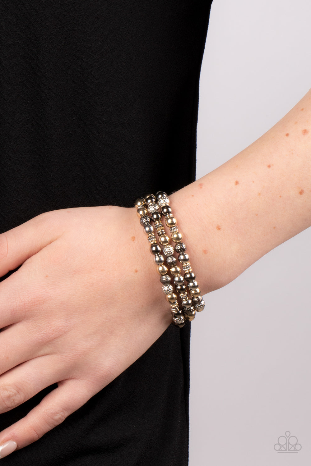Paparazzi Accessories - Boundless Boundaries - Multi Beaded Bracelets a gritty collection of smooth, studded, and textured gold, gunmetal, and silver beads are threaded along stretchy bands around the wrist, creating dainty layers. Sold as one set of three bracelets.