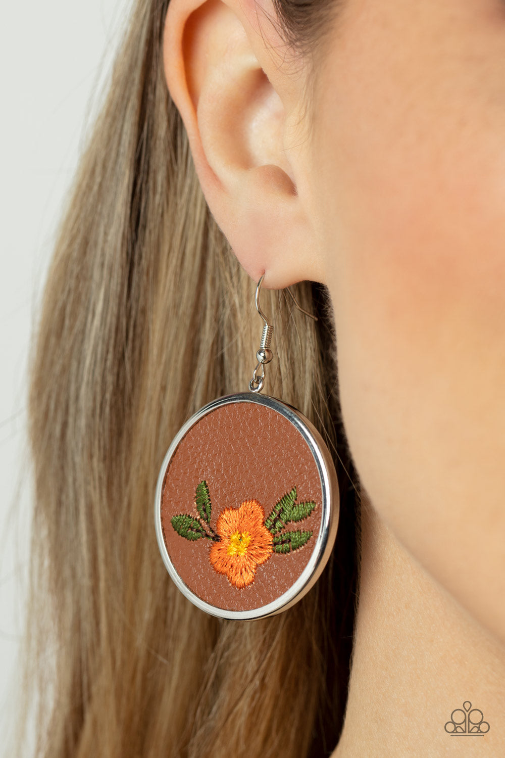 Paparazzi Prairie Patchwork -Orange Leather Earrings leafy orange flower is embroidered along the bottom of a piece of leather that is encased in a sleek silver frame, blooming into a homespun fashion. Earring attaches to a standard fishhook fitting.  Sold as one pair of earrings.