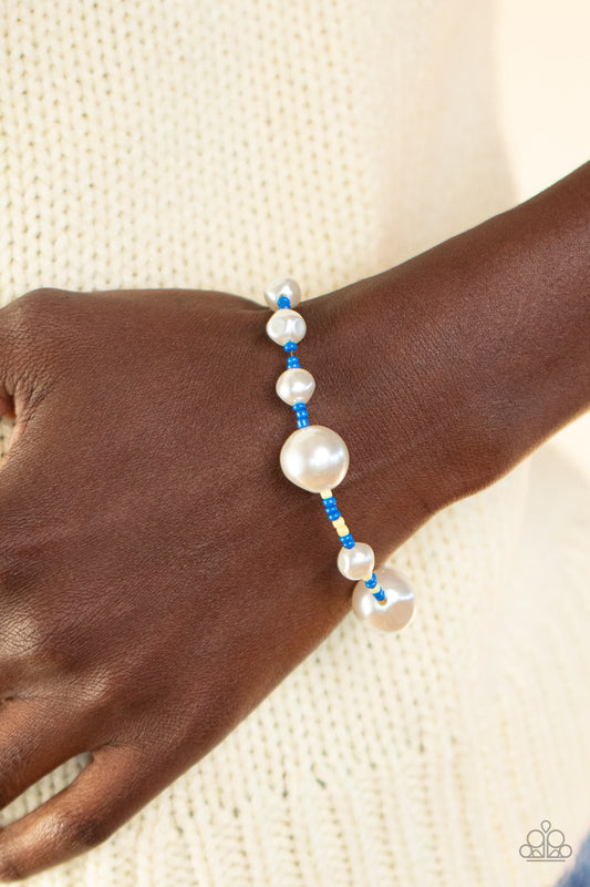 Contemporary Coastline - Blue Seedbead Bracelets rregular-shaped pearls in varying sizes are scattered amongst blue and yellow seed beads that are threaded along a wire, resulting in a refreshing and playful style around the wrist. Features an adjustable clasp closure.  Sold as one individual bracelet.  Get The Complete Look! Necklace: "Modern Marina - Blue" (Sold Separately