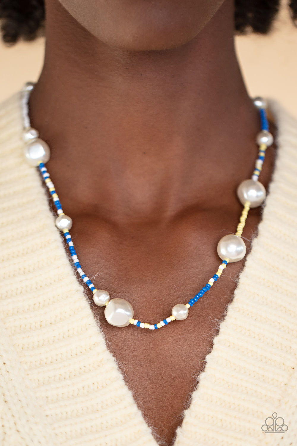 Modern Marina - Blue Seedbead Necklaces irregular-shaped pearls in varying sizes are scattered amongst blue, yellow, and white seed beads that are threaded along a wire, resulting in a refreshing and playful style below the collar.  Sold as one individual necklace. Includes one pair of matching earrings.  Get The Complete Look! Bracelet: "Contemporary Coastline - Blue" (Sold Separately)