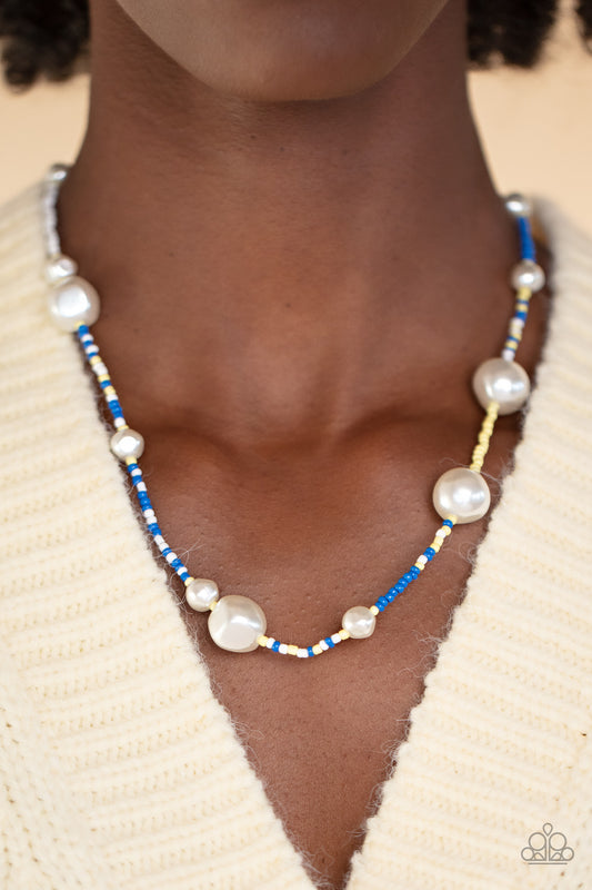 Modern Marina - Blue Seedbead Necklaces irregular-shaped pearls in varying sizes are scattered amongst blue, yellow, and white seed beads that are threaded along a wire, resulting in a refreshing and playful style below the collar.  Sold as one individual necklace. Includes one pair of matching earrings.  Get The Complete Look! Bracelet: "Contemporary Coastline - Blue" (Sold Separately)