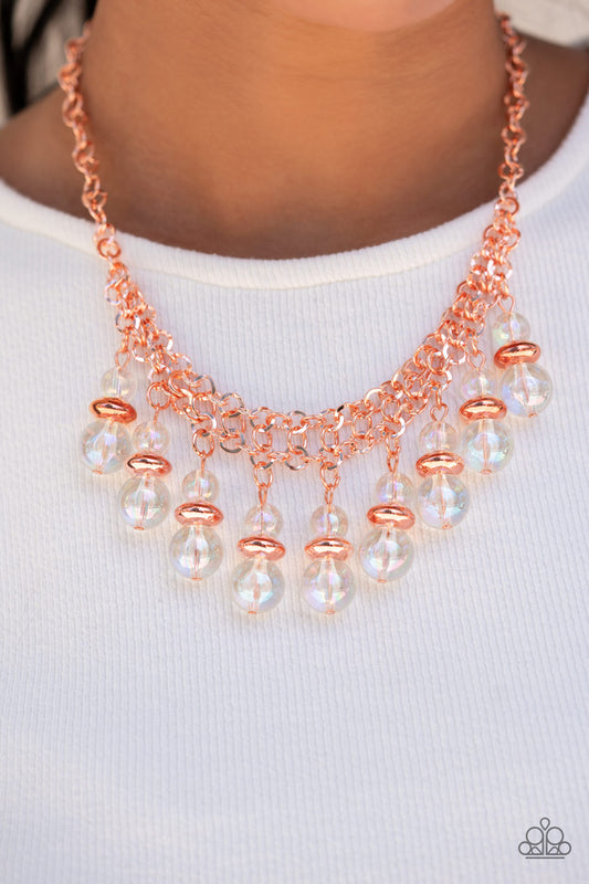Paparazzi Accessories Deep Space Diva - Copper Iridescence Convention Necklaces featuring a stellar iridescence, pairs of glassy beads are separated by shiny copper discs, trickling below the collar in an effervescent fringe. Features an adjustable clasp closure. Due to its prismatic palette, color may vary.  Sold as one individual necklace. Includes one pair of matching earrings.  2022 Glow Convention
