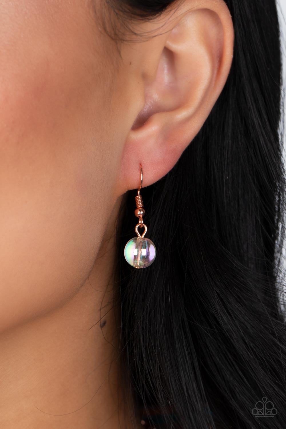 Bubbly iridescent beads in varying sizes drape along the collar, creating a glittery magical effect. Shiny copper cap fittings wrap around the smaller beads, adding vintage metallic detail to the effervescent design. Features an adjustable clasp closure. Due to its prismatic palette, color may vary.  Sold as one individual necklace. Includes one pair of matching earrings.  Get The Complete Look! Bracelet: "Iridescent Illusions - Copper" (Sold Separately)
