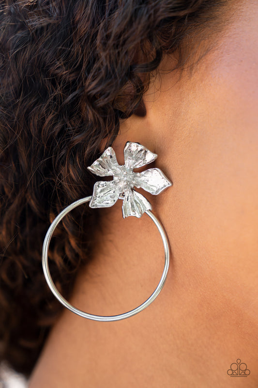 Paparazzi Accessories - Buttercup Bliss - Silver August 2022 Life of the Party Earrings  featuring lifelike textures, a shimmery silver buttercup blooms atop an oversized silver hoop for a whimsical allure. Earring attaches to a standard post fitting.  Sold as one pair of post earrings.