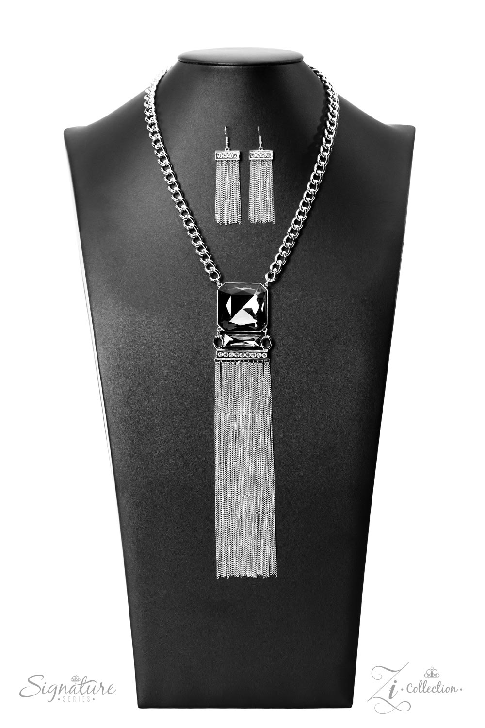 dramatically oversized, smoky, Asscher cut gem sits boldly at the bottom of a thick silver chain, creating a majestic focal point. An emerald cut gem in the same smoky hue connects to the bottom of the large centerpiece, followed by a thick silver bar lined with sparkling white rhinestones. The jaw-dropping frames stack into a mesmerizing pendant that gives way to a stream of silver chains, captivating onlookers with every swish of its spellbinding sashay.