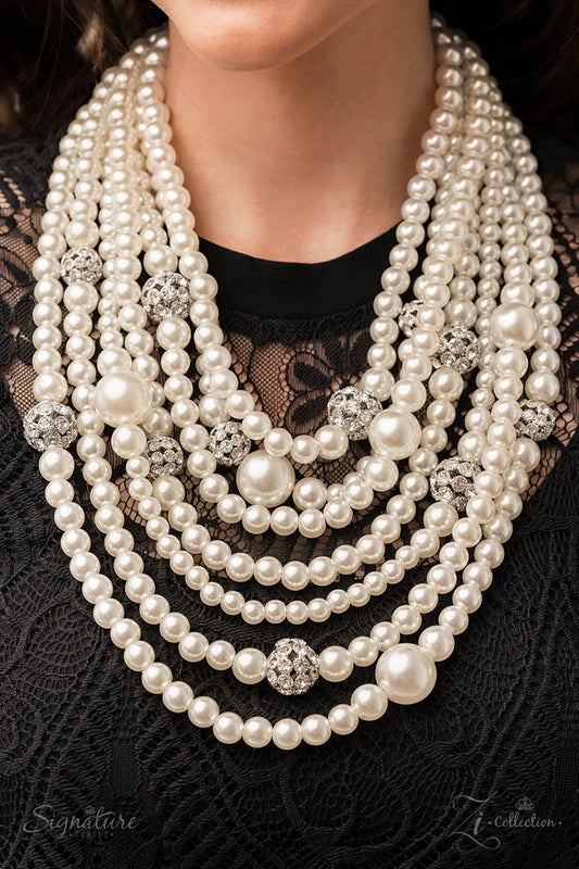 Paparazzi Accessories The Courtney - 2022 Signature Zi Collection Necklace strand after strand of lustrous white pearls layer down the chest, creating timeless tiers. Airy silver spheres, adorned in sparkling white rhinestones, are effortlessly sprinkled among the sea of pearls, infusing the design with capricious shimmer, while larger pearl beads add dimension and depth to this classic motif. Features an adjustable clasp closure.  Sold as one individual necklace. Includes one pair of matching earrings.
