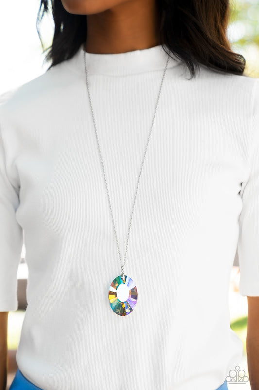 Paparazzi Accessories Celestial Essence - Multi Iridescent Convention Necklaces featuring a reflective focal point and an exaggerated faceted surface, a dramatically oversized, iridescent gem sparkles at the bottom of a lengthened silver chain for an out-of-this-world kind of dazzle. Features an adjustable clasp closure. Due to its prismatic palette, color may vary.  Sold as one individual necklace. Includes one pair of matching earrings.  2022 Glow Convention