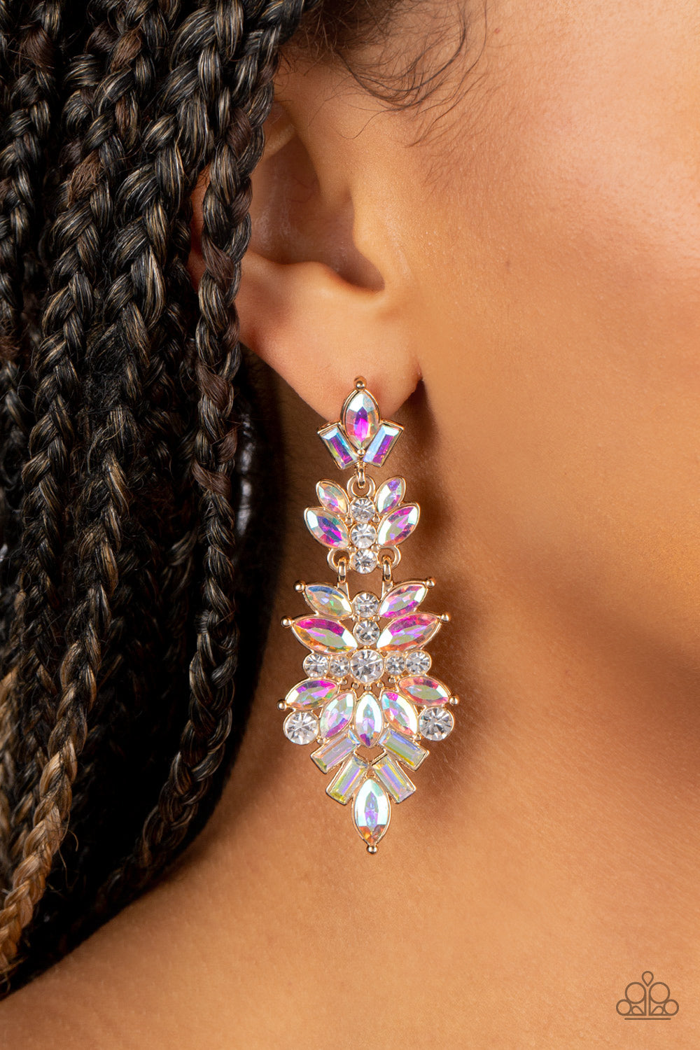 Paparazzi Accessories Frozen Fairytale - Multi Iridescent Rhinestone Earrings featuring white and iridescent finishes, trestles of round, marquise, and emerald cut rhinestones cluster into three sparkly segments as they link into a jaw-dropping lure. Earring attaches to a standard post fitting. Due to its prismatic palette, color may vary. Sold as one pair of post earrings.
