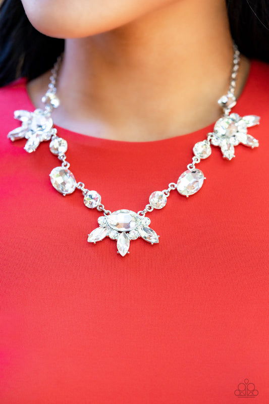 Paparazzi Accessories Glow-Trotting Twinkle - White Rhinestone Convention Necklaces brilliant white rhinestones in round, oval, and marquise cuts, create an abstract pattern as they fall along the neckline. The faceted surfaces of each gem catch and reflect light from every angle, resulting in a timelss, twinkling statement piece. Features an adjustable clasp closure.  Sold as one individual necklace. Includes one pair of matching earrings.  2022 Glow Convention