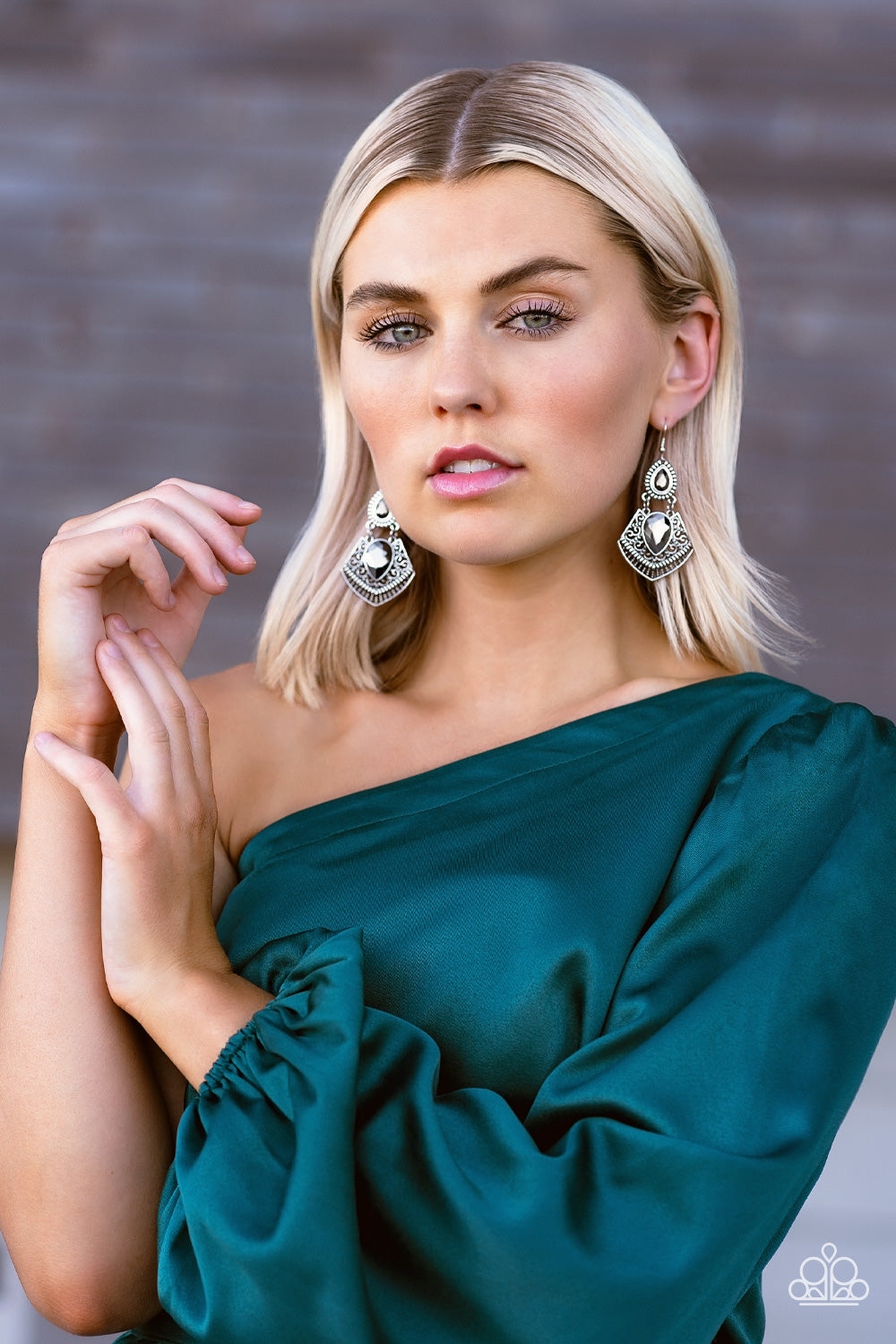 Paparazzi Accessories Royal Remix - Silver Gem Convention Earrings hematite teardrop gem is pressed into a flared silver frame swirled in intricate patterns. The flared frame swings below a smaller hematite teardrop that is wrapped in a border of silver studs, creating a swinging statement. Earring attaches to a standard fishhook fitting. Sold as one pair of earrings. 2022 Glow Convention