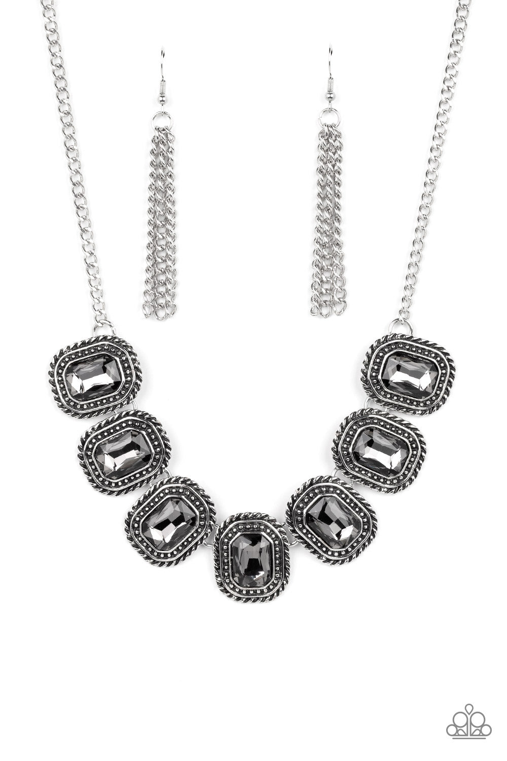 Paparazzi Accessories Iced Iron - Silver Convention Necklaces pressed into silver, chain-like frames, radiant-cut hematite rhinestones smolder below the collar in a jaw-dropping finish. Features an adjustable clasp closure.  Sold as one individual necklace. Includes one pair of matching earrings.  2022 Glow Convention