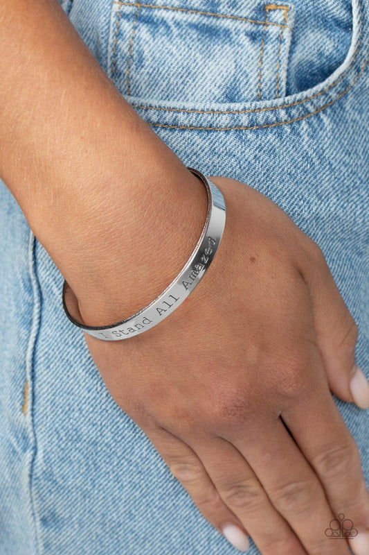 Paparazzi Accessories - I Stand All Amazed - Silver Inspirational Bracelets a simplistic, shiny, silver cuff is stamped with the phrase "I Stand All Amazed," for a divine, light-catching design across the wrist.  Sold as one individual bracelet.