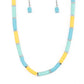 Rubber discs in shades of Waterspout, Primrose, and turquoise are threaded along an invisible wire, adorning the collar in a courageous pop of color. Shiny silver discs separate the bands of color, adding a hint of industrial sheen to the youthful design. Features an adjustable clasp closure.  Sold as one individual necklace. Includes one pair of matching earrings.