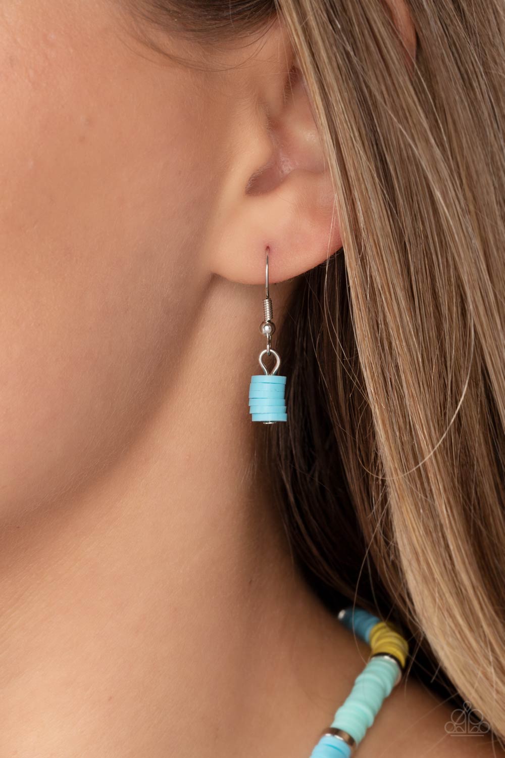 Rubber discs in shades of Waterspout, Primrose, and turquoise are threaded along an invisible wire, adorning the collar in a courageous pop of color. Shiny silver discs separate the bands of color, adding a hint of industrial sheen to the youthful design. Features an adjustable clasp closure. Sold as one individual necklace. Includes one pair of matching earrings.