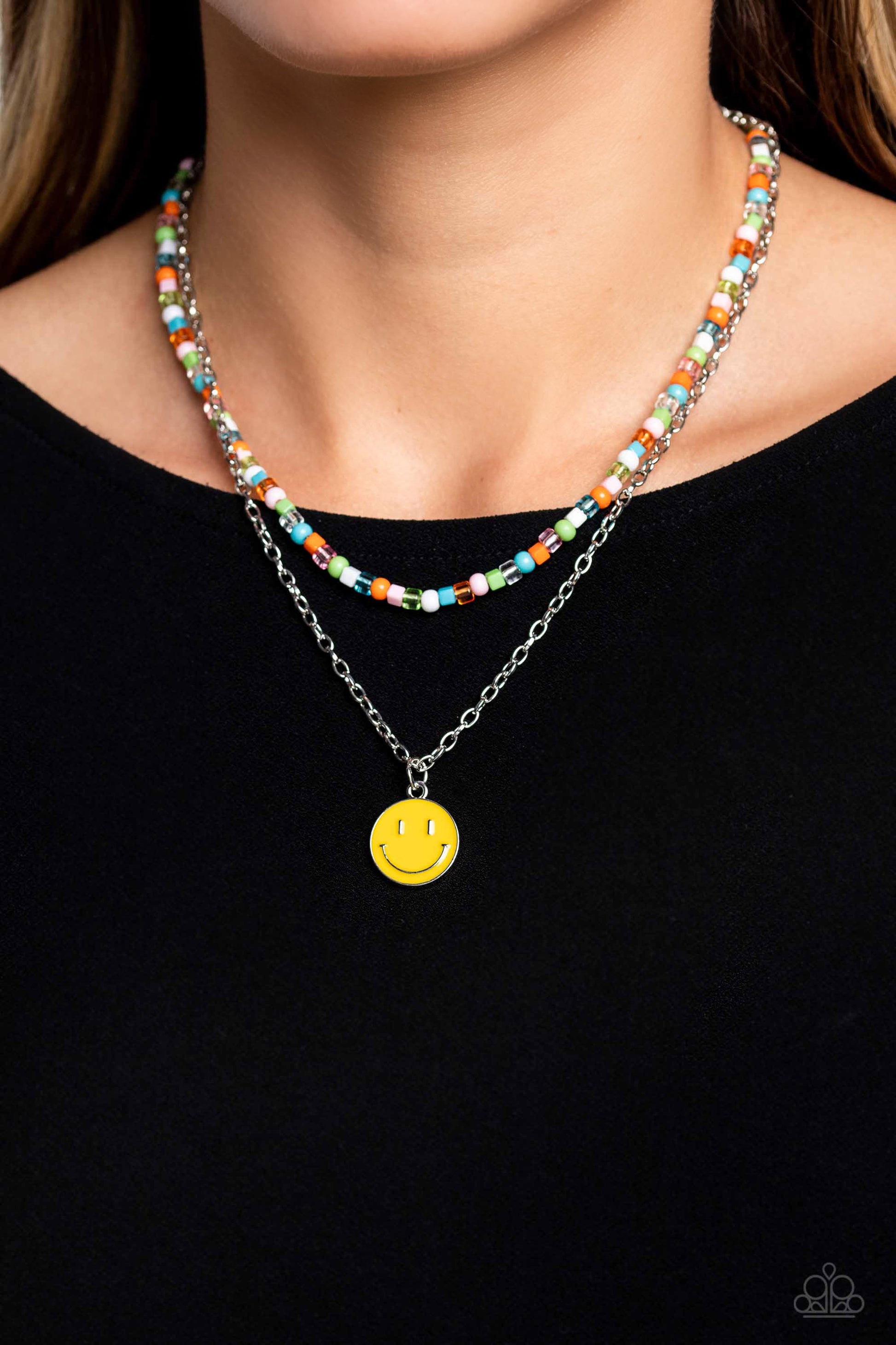 Paparazzi Accessories - High School Reunion - Multi Necklaces gliding from a dainty, silver chain, a smiley face pendant stands out against a yellow backdrop. Completing the charismatic ensemble, a collection of seed beads in shades of baby pink, apple green, white, orange, and turquoise create bright pops of color around the neckline for a youthful finish. Features an adjustable clasp closure.  Sold as one individual necklace. Includes one pair of matching earrings.
