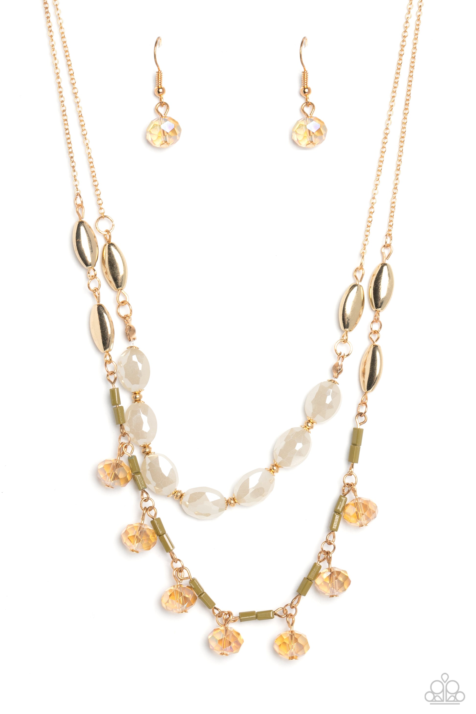 Two strands of dainty gold chain are adorned in a collection of white opaque beads, faceted glass beads, and gold accents, culminating in a layered design rich with vintage character. The glassy beads that swing along the lower chain feature a subtle reflective surface in a cozy peach glow, complementing the opaque beading that lines the chain above, with tiny gold and olive green accents sprinkled throughout the piece in a rustic finish. Features an adjustable clasp closure.