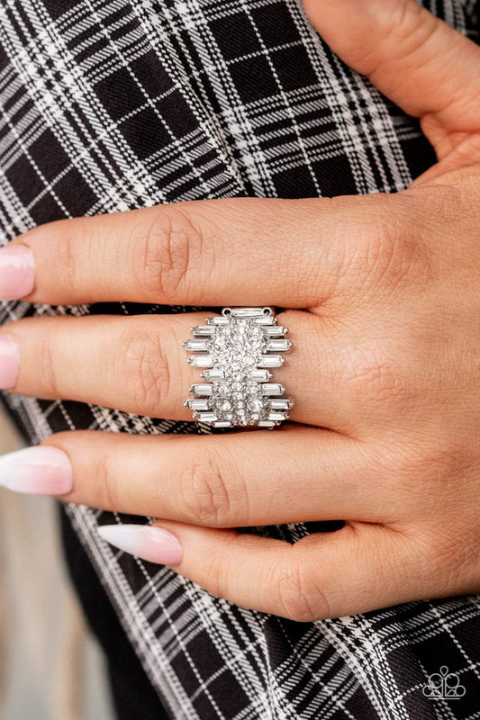 Urban Empire - White Rhinestone Life of The Party Rings staggered rows of emerald cut rhinestones flare out from the top and bottom of an explosion of classic white rhinestones, creating a smoldering statement piece atop the finger. Features a stretchy band for a flexible fit.
Sold as one individual ring.