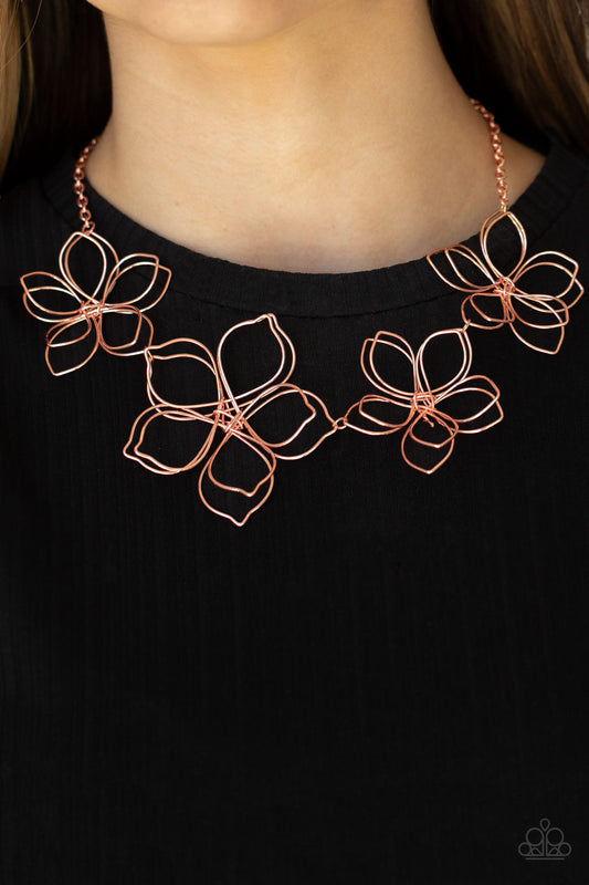 Paparazzi Accessories Flower Garden Fashionista - Copper Necklaces shiny copper wire delicately twists into oversized blossoms. Varying in size, the airy floral frames delicately link into an asymmetrical display as the layered frames elegantly pop beneath the collar. Features an adjustable clasp closure.