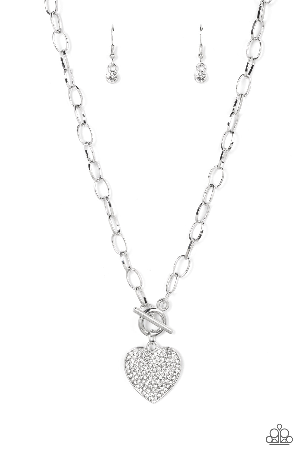 If You LUST - White Rhinestone Heart Necklaces a white rhinestone dotted silver heart frame sparkles from a toggle closure at the center of an oval silver linked chain for a flirtatious fashion. Features a toggle closure.  Sold as one individual necklace. Includes one pair of matching earrings.