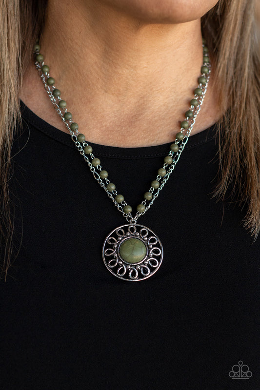 Paparazzi Accessories Sahara Suburb - Green Necklaces dainty silver chain is paired with a grounding green stone beaded chain below the collar. An oversized green stone adorns the center of an antiqued silver frame radiating with silver studded and wire-like detail, creating an authentic artisan inspired pendant at the bottom of the earthy chains. Features an adjustable clasp closure.