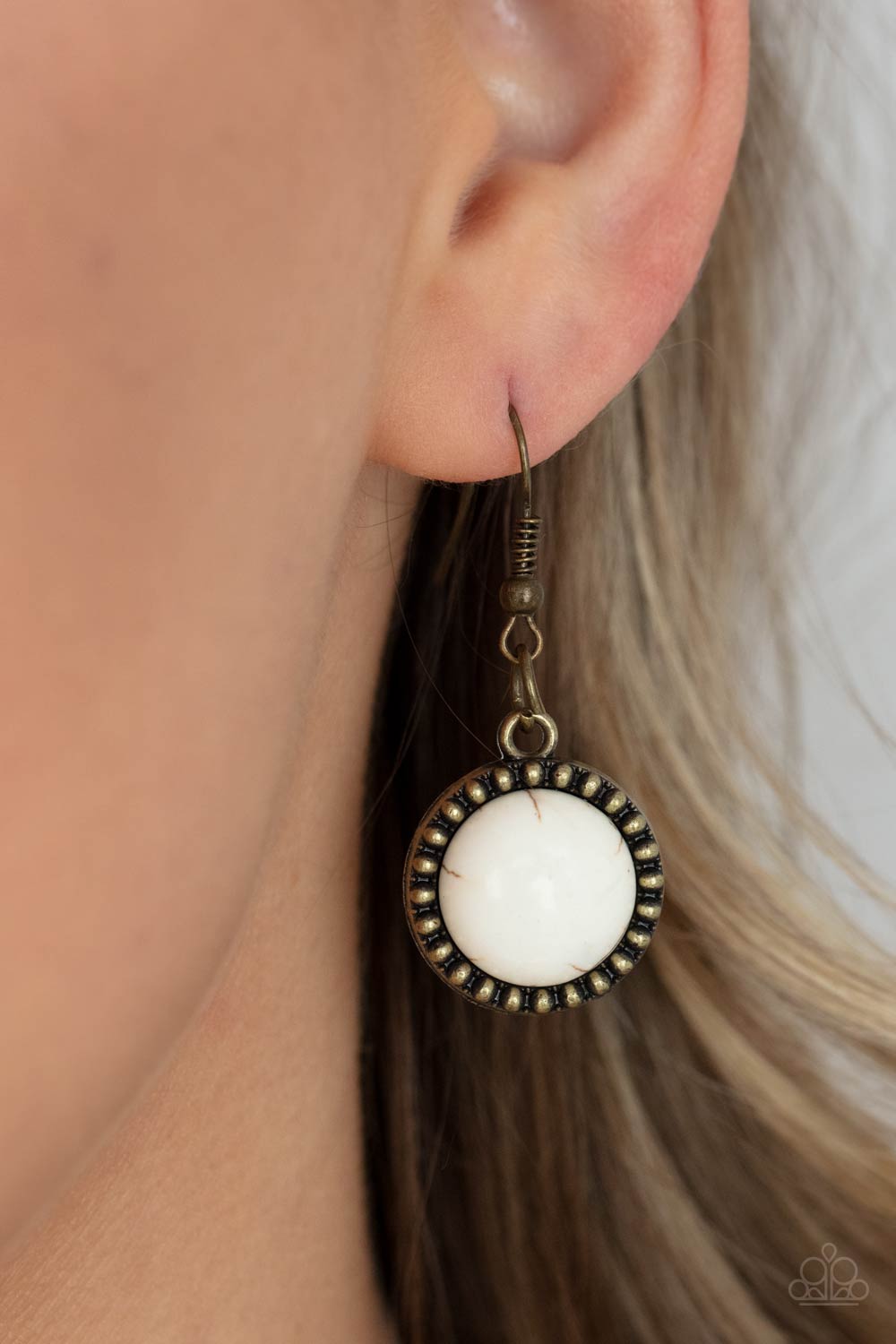 She Went West - Brass Frame White Stone Necklaces earthy white stones, pressed into round antiqued brass frames featuring dot and interlinking loop motifs, create a dramatically rustic statement as they link across the collar. Features an adjustable clasp closure. Sold as one individual necklace. Includes one pair of matching earrings. Paparazzi Jewelry is lead and nickel free so it's perfect for sensitive skin too!