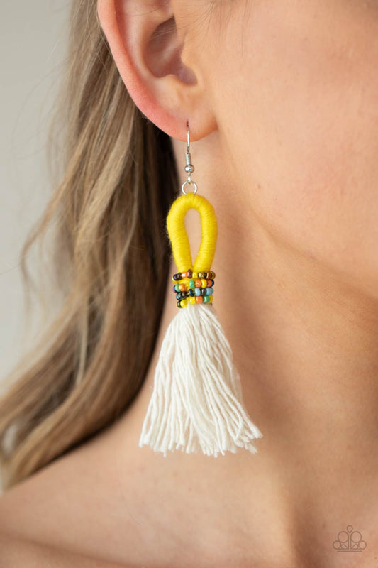 The Dustup - Yellow Earrings a tassel of soft white cotton fans out under rows of brightly colored seed beads. Anchored by a loop of vibrant yellow floss, the eye-catching style swings from the ear for a show-stopping statement. Earring attaches to a standard fishhook fitting.  Sold as one pair of earrings.  Paparazzi Jewelry is lead and nickel free so it's perfect for sensitive skin too!