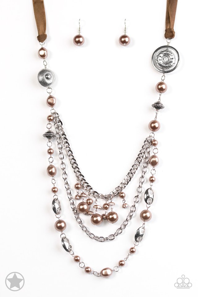 Brown Necklaces a silky brown ribbon replaces a traditional chain to give an elegant look. Pearly brown beads and funky silver pieces intermix with varying lengths of silver chains to give a fresh take on a Victorian-inspired piece.