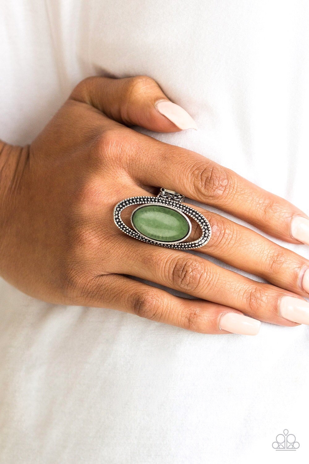Western Royalty - Green Stone Rings a studded silver frame encircles an earthy stone center, creating a dramatic Southwestern inspired look atop the finger. As the stone elements in this piece are natural, some color variation is normal. Features a stretchy band for a flexible fit.
Sold as one individual ring.